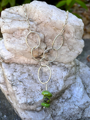 Long silver necklace with green stone nugget beads drop